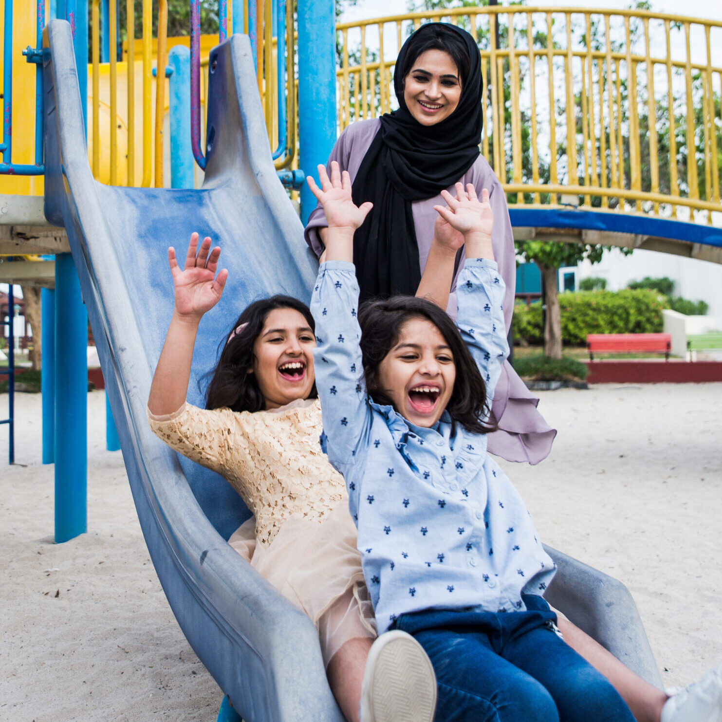 Mom and daughters spending time together at the park, in Dubai