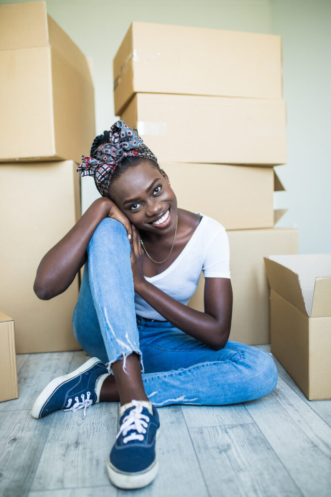 Young woman happily about moving into new space. Alternatives Inc