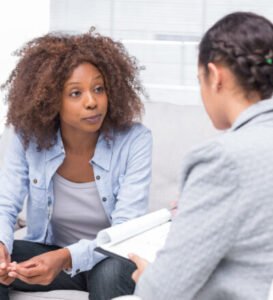 Two women conducting case management through Alternatives Inc